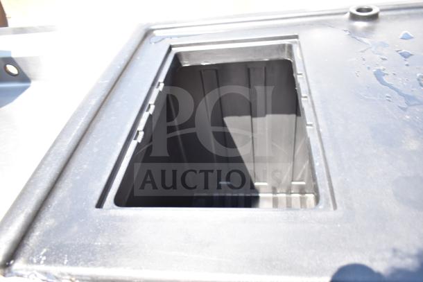 Alt text: Cambro CVC55110 Camcruiser black vending cart counter well, brand new with minor scratches and dents.