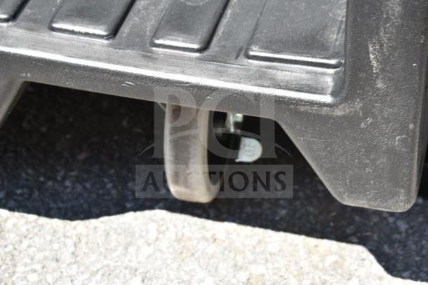 Black Cambro CVC55110 Camcruiser vending cart wheel in focus, highlighting durable construction, scratch and dent condition.