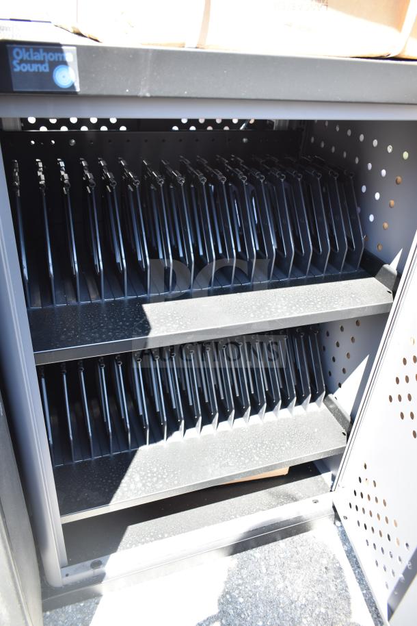 BRAND NEW Oklahoma Sound DCC Black and Charcoal Duet Charging Cart with shelves; minor scratches visible; logo on top.