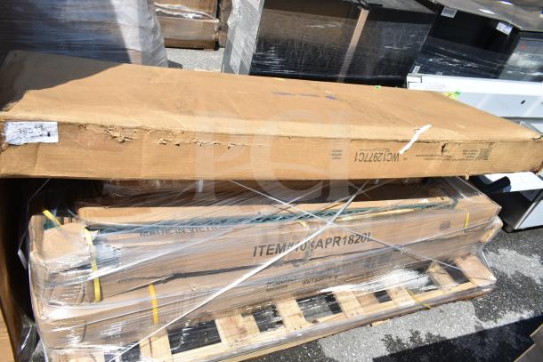 8 sealed boxes of scratch and dent items, including a pan rack and work table, on a pallet. Boxes show item codes and shipping labels.