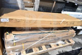 8 sealed boxes of scratch and dent items, including a pan rack and work table, on a pallet. Boxes show item codes and shipping labels.