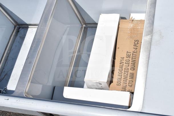 BRAND NEW SCRATCH AND DENT Regency 600S21824224 commercial 2-bay sink with dual drain boards, visible packaging.