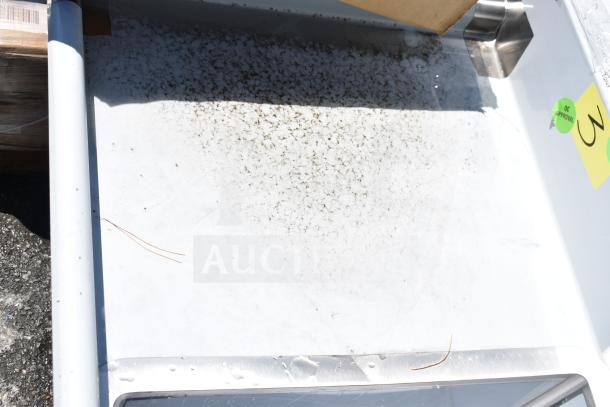 Brand new Regency 600S21824224 commercial 2-bay sink with dual drain boards, visible QC Approval label, minor scratch.