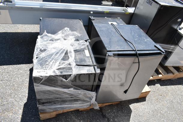 Four mini coolers, including Galanz GL27S5, Galanz GL17BK, Magic Chef HMAR170BE, wrapped for auction, use 120 Volts.