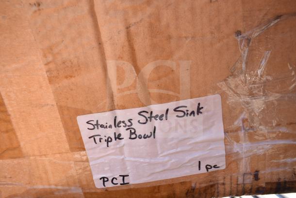 Label on cardboard box reads "Stainless Steel Sink Triple Bowl, PCI, 1pc." Part of auction for five scratch and dent items.