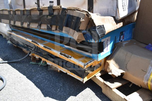 Stack of five brand new, scratch and dent items, including sink, visible in damaged packaging. Labels indicate Philips Roku TV.