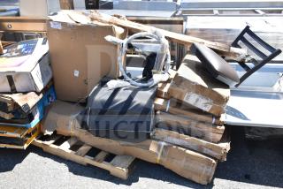 Stack of 10 new scratch and dent items including hood filters and table base, in original packaging on wooden pallet.
