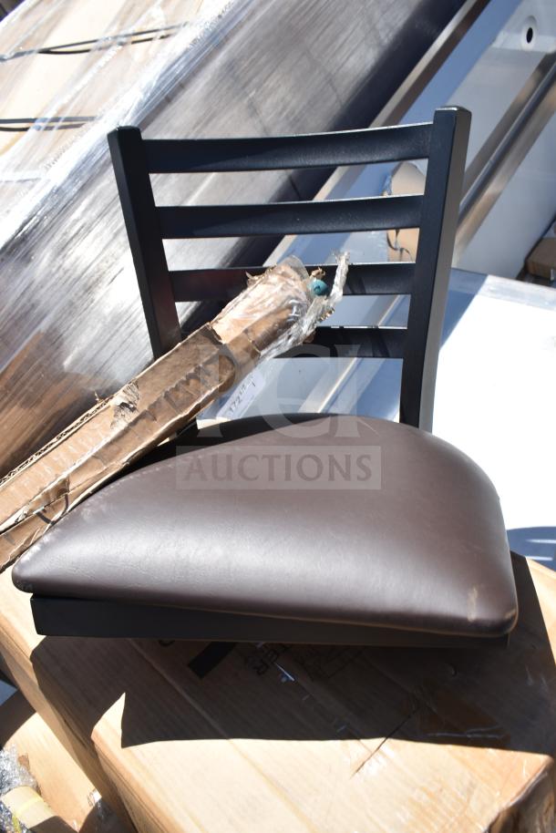 Black chair with brown cushioned seat and flat metal backrest, part of a lot including hood filters and table base. Brand new but scratch and dent condition.