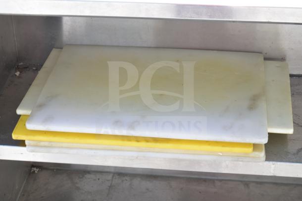 Commercial stainless steel table with two under shelves, mounted commercial can opener, cutting boards, and chafer. Used condition.