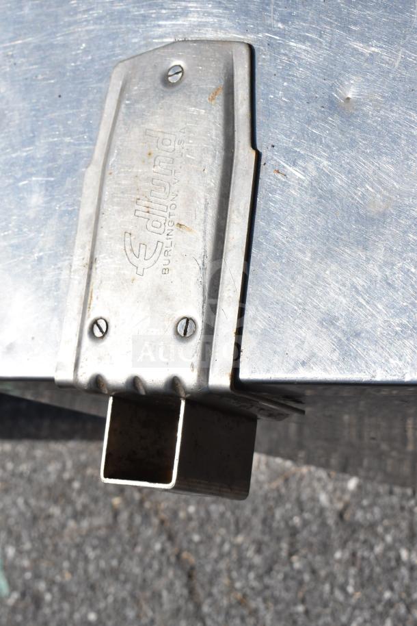Stainless steel commercial table with two under shelves and an Edlund can opener mount, includes cutting boards and chafer.