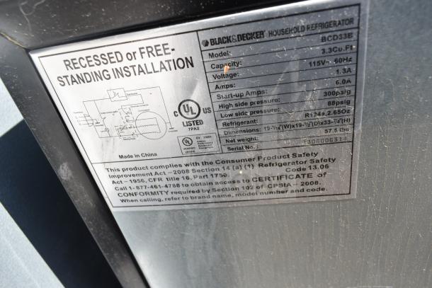 Label on Black & Decker BCD33B cooler showing specifications: 3.3 Cu. Ft., 115V, 1.3A, R134a refrigerant. UL listed. Made in China.