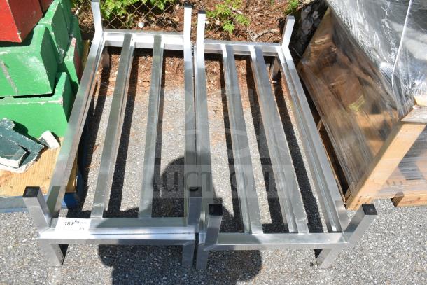 4 new Regency 48" x 20" x 8" aluminum dunnage racks with 1685 lb. capacity each, slight scratches and dents visible.