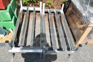 4 new Regency 48" x 20" x 8" aluminum dunnage racks with 1685 lb. capacity each, slight scratches and dents visible.