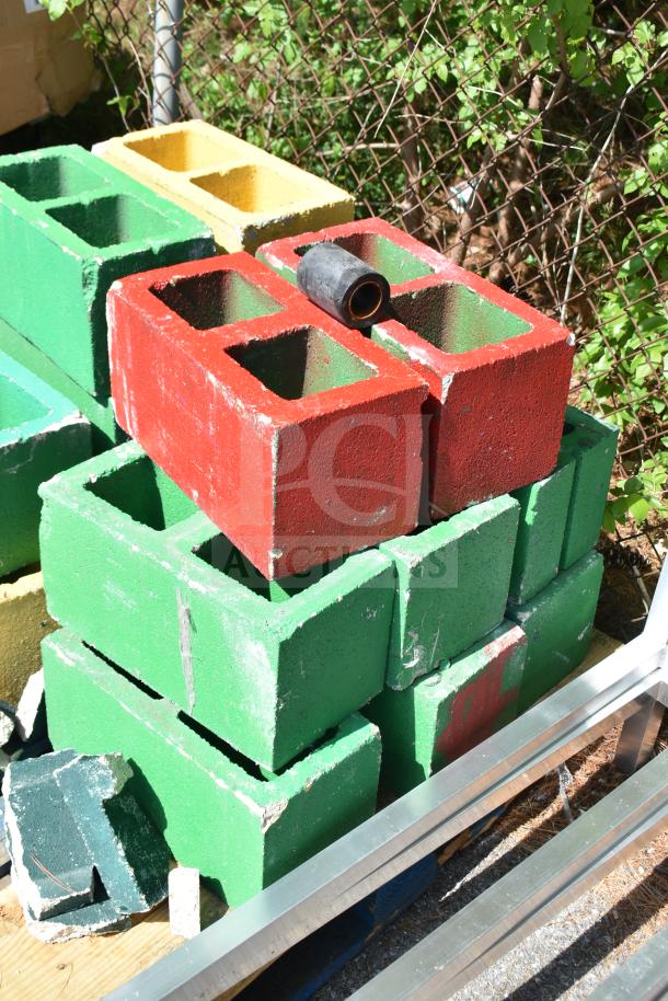 Colorful painted cinderblocks, red and green, totaling 16. Mixed condition, suitable for decorative or structural use.