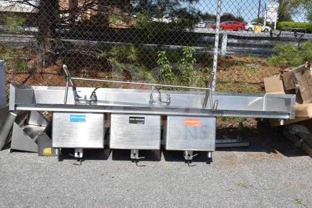 Commercial 3 bay sink with dual drain boards, stainless steel, labeled for wash, rinse, sanitize. Used condition.