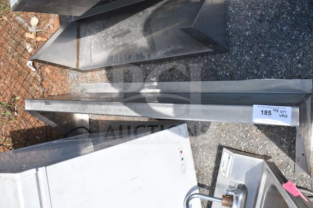 Four items including three metal shelves and a drop-in sink strainer, labeled lot number 185.