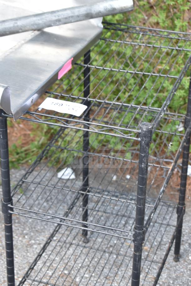 Two metal shelving units, wire design, black, with visible wear. Buyer must dismantle. Note mentions freight charges.