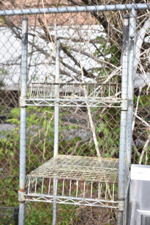 Metal shelving units outdoors, weathered, three wire shelves, buyer must dismantle, freight charges apply.