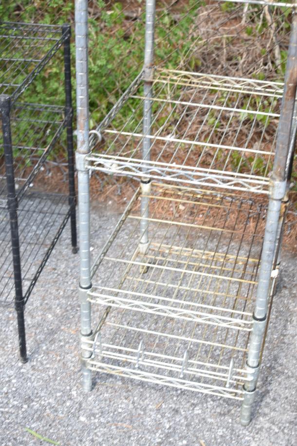 Two metal shelving units with visible wear, wire mesh shelves, and sturdy frame. Buyer must dismantle and consider freight.