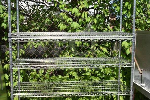 Chrome finish 5-tier wire shelving unit outdoors. Good condition, requires buyer dismantling. Consider freight charges.