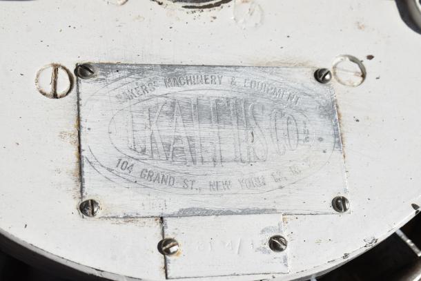 I. Kalfus Co commercial countertop dough divider on wooden stand, metal tag with 104 Grand St, NY address, worn condition.