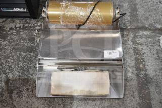 Countertop wrapping station with plastic wrap roll, 120 volts, 1 phase, stainless steel, minor wear, auction tag visible.