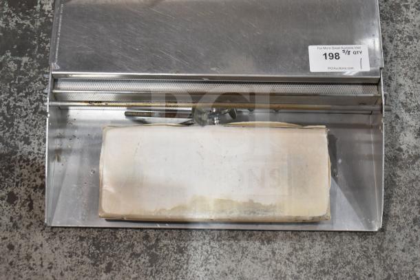 Countertop wrapping station, stainless steel, 120 volts, single phase, features a cutting bar, tag visible with auction info.