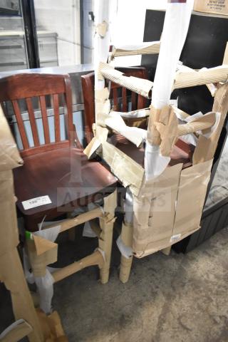Three brand new wooden bar height chairs with protective wrapping. Visible minor scratches and cardboard padding.