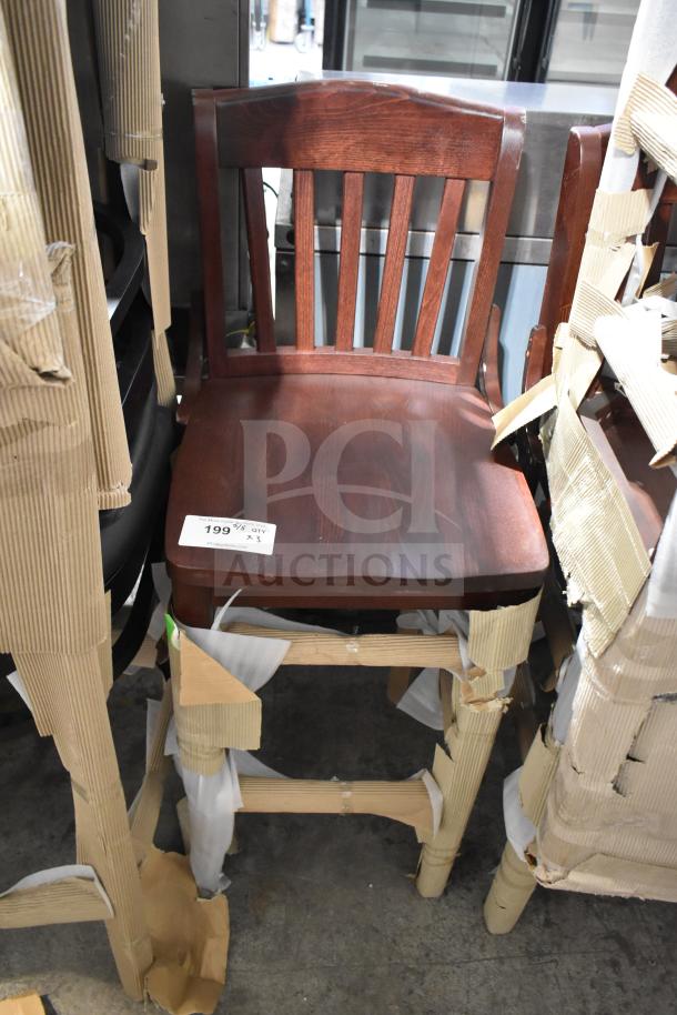 Three brand new wooden bar height chairs, slightly scratched and dented, packed in protective cardboard wrapping.