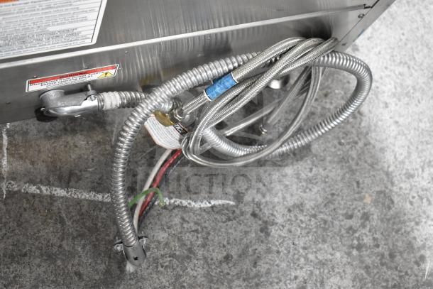 2023 Fetco CBS-2152-XTS coffee brewer cables and warning label visible, showing 208-240 volts wiring setup.