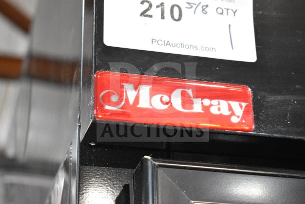 McCray GF48-CAR-BE-DHL commercial cooler detail showing logo. Features include commercial casters and dual doors.