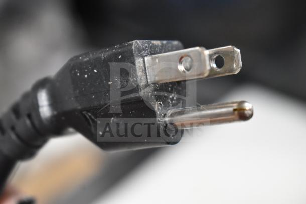 Close-up of a black 115V electrical plug, likely for the Avantco 178SSPT60HC commercial prep table.