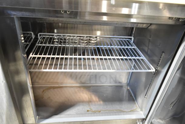 2022 Avantco 178SSPT60HC commercial sandwich salad prep table interior, featuring shelves and stainless steel construction.