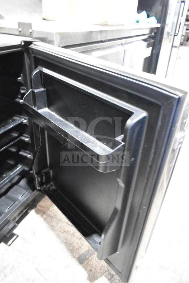 Summit Mini Cooler with open door showing interior shelving. Black finish. Used condition. No visible labels or markings.