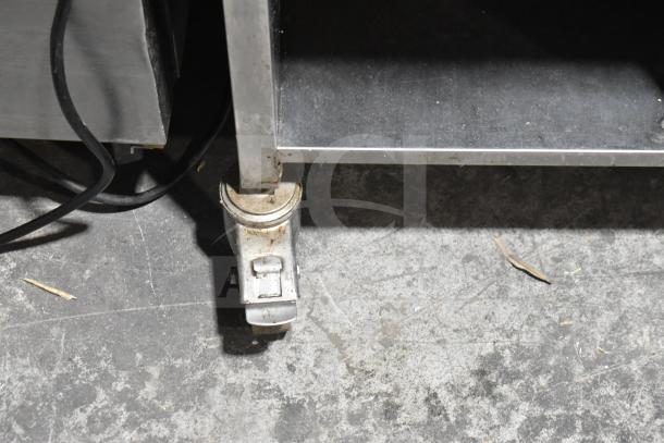 Caster wheel of the Rational SCC WE 62G combi oven stand, showing signs of wear on a concrete floor.
