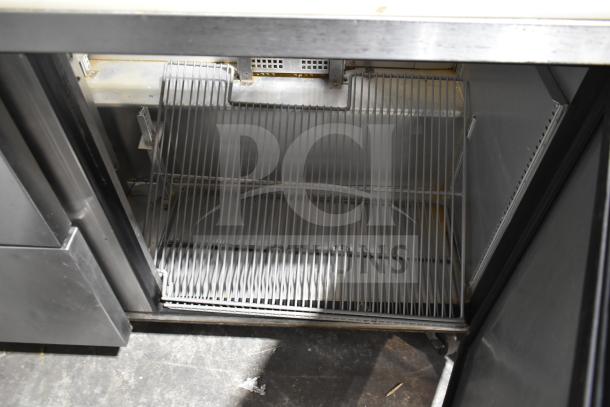 2019 True TSSU-60-16D-2-HC commercial sandwich prep table interior, steel wire shelving, electrical components visible.