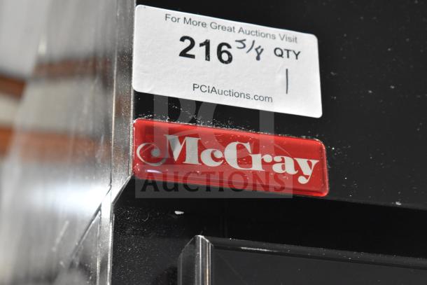 McCray GF48-CAR-BE-DHL commercial freezer, 2-door, on casters with visible McCray logo and auction tag. 115/208-230V, 1 phase.