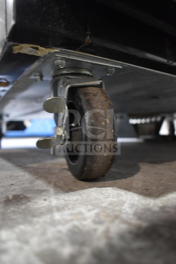 McCray GF48-CAR-BE-DHL 2-door freezer casters; commercial use, sturdy, showing wear, essential for mobility.