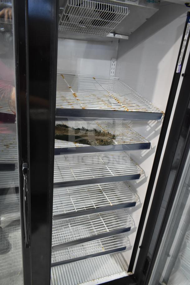 McCray GF48-CAR-BE-DHL commercial 2 door freezer, interior shelves, commercial casters, visible wear. Model on label.