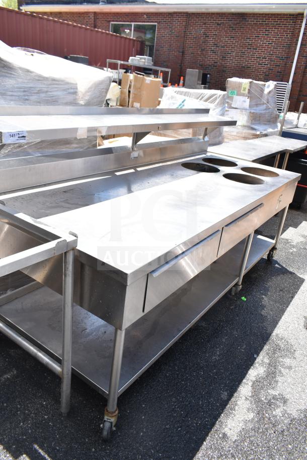 Commercial prep table with four round cutouts, two drawers for sauce pots, on commercial casters. Stainless steel.