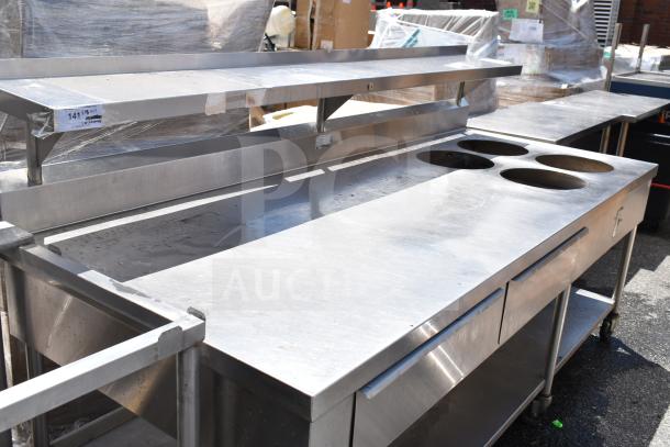Commercial prep table with 4 round cutouts, 2 drawers with sauce pot cutouts, on commercial casters.