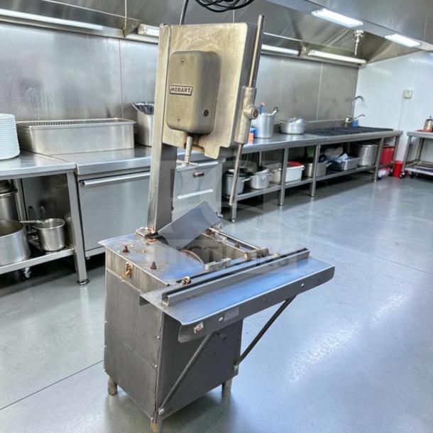 Hobart 5614 commercial meat saw, 2 HP, 3 phase, for parts or repair, steel construction, visible wear, located in kitchen.