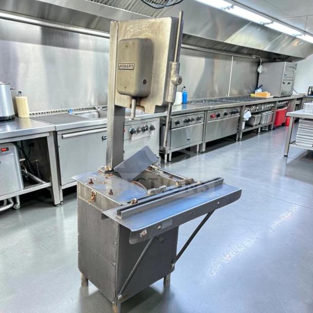 Hobart 5614 commercial meat saw, 2 HP, 3-phase, for parts or repair, visible Hobart branding. Heavy-duty design.