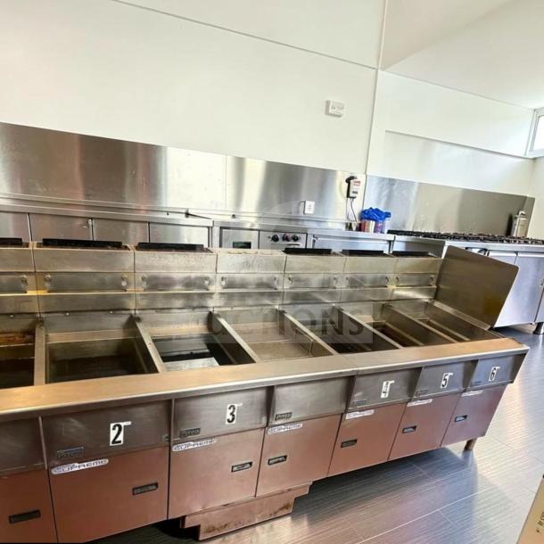 Pitco SSH55 commercial gas fryer battery; 5 units, 50 lb vats each, natural gas, built-in filtration, excellent condition.