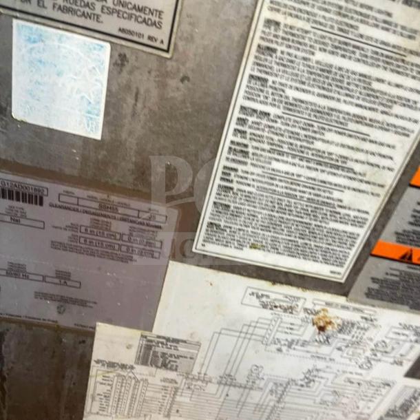 Labels and schematics on the Pitco SSH55 commercial gas fryer, model details and specifications visible.