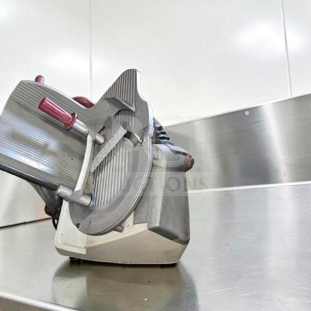 Berkel X13-PLUS 13" manual meat slicer in exceptional condition, 1/2 HP, fully tested and operational, on stainless steel surface.