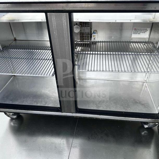 True TSSU-48-12-HC sandwich prep table, 48", refrigerated base, stainless steel, top-tier condition, interior view.