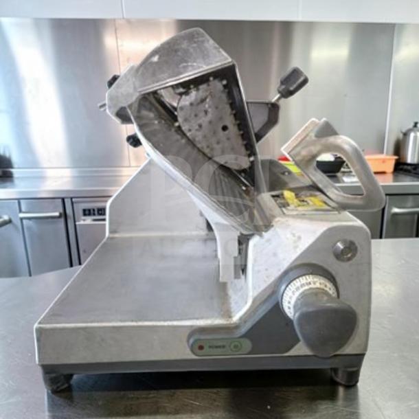 German Knife GS-12M slicer in exceptional condition, 12" gravity feed, 1/2 HP, UL & NSF certified, fully tested.