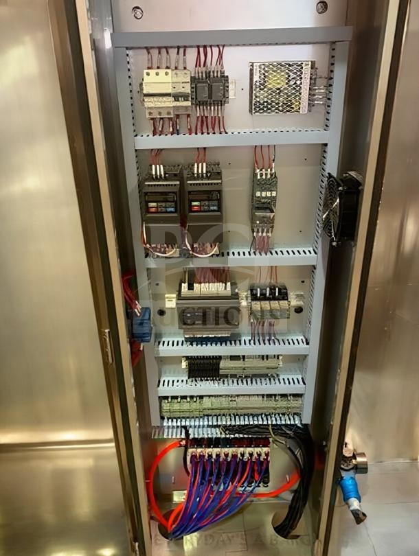 Interior view of TANG Two-Head Automatic Filling Machine's control panel, showcasing wiring and components.