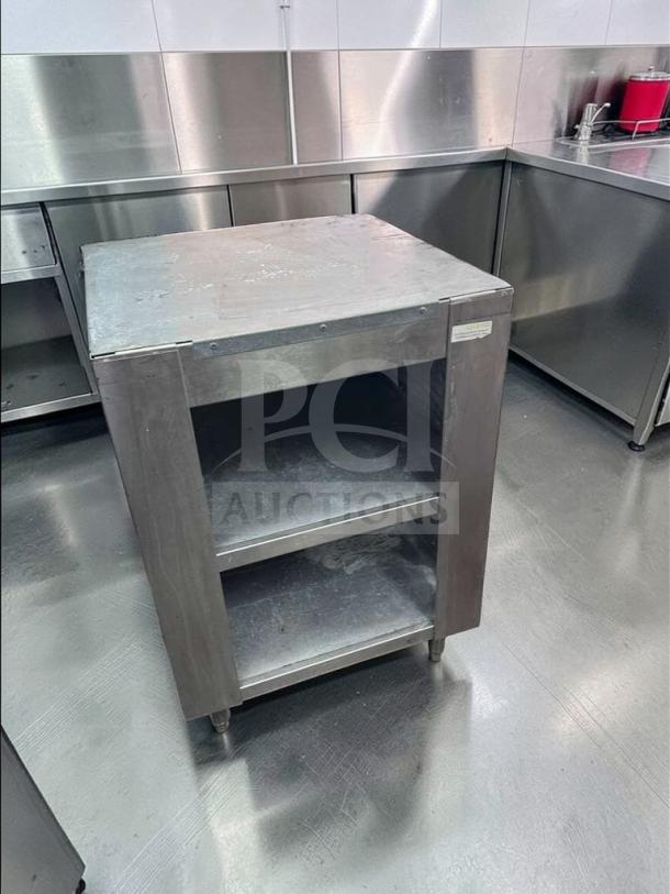 Commercial stainless steel equipment stand, excellent condition, heavy-duty, open shelf, model COM-S-STD-0687. Ideal for kitchen use.
